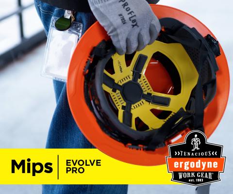 Worker holding an orange type 2 safety helmet with MIPS protection